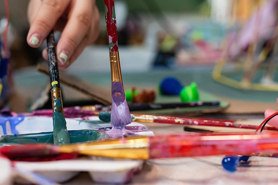 Kreativangebote Kind beim Malen mit Pinsel und Farbe